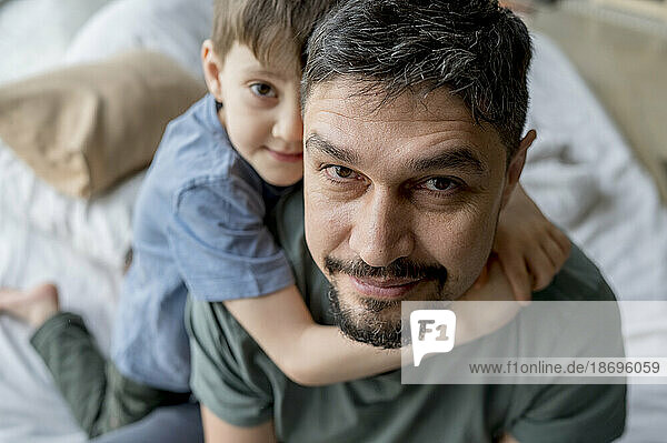Father with cute son at home