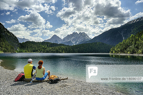 Austria  Tyrol  Hiking couple relaxing on shore of Blindsee