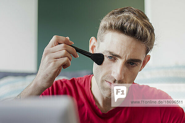 Man applying make-up with brush