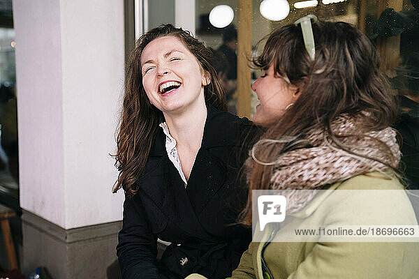 Happy female friends laughing together