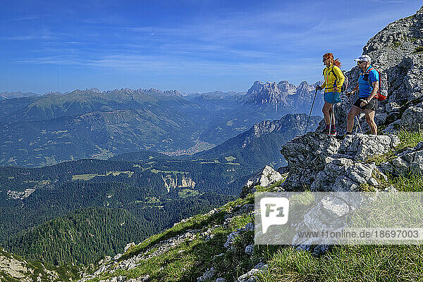 Italy  Province of Belluno  Pair of hikers admiring views along Alta Via Dolomiti Bellunesi trail