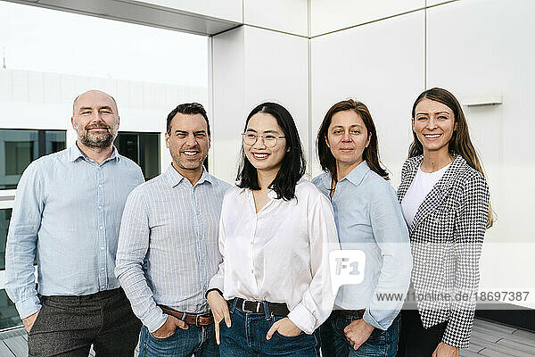 Portrait of confident business team on terrace of office building