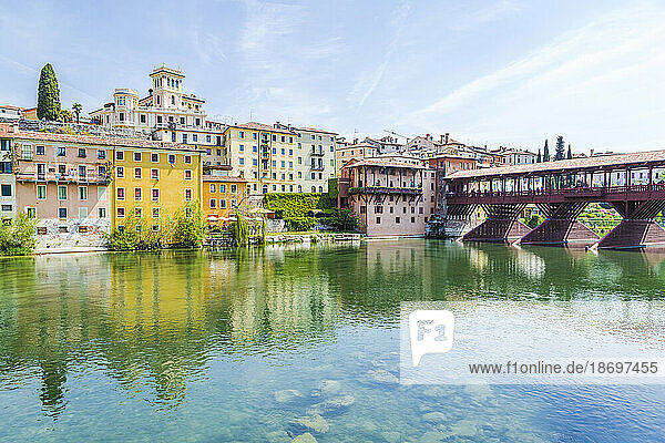 Italy  Veneto  Bassano del Grappa  River Brenta with buildings and Ponte Vecchio in background