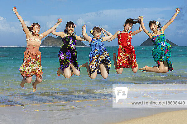Group of Japanese students on vacation at Lanakai Beach with the Mokes Islands in the background Oahu  Hawaii  United States of America