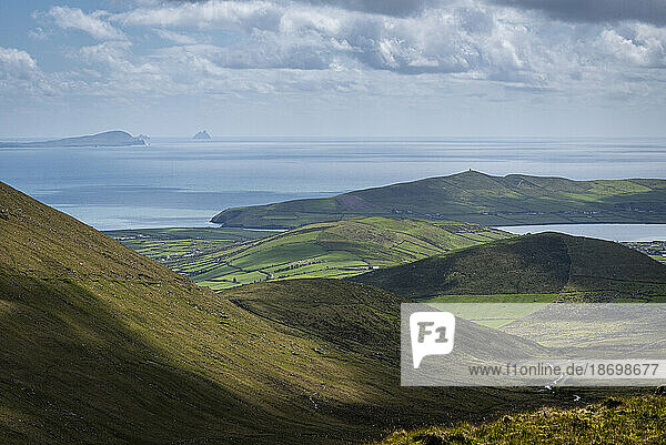 Scenic view of the Conor Pass and mountainous farmland  looking towards Dingle and Skellig Michael on the Atlantic Ocean; County Kerry  Ireland