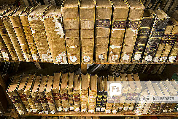 Worn books on a shelf about the history of England in South India.; Ooty  India