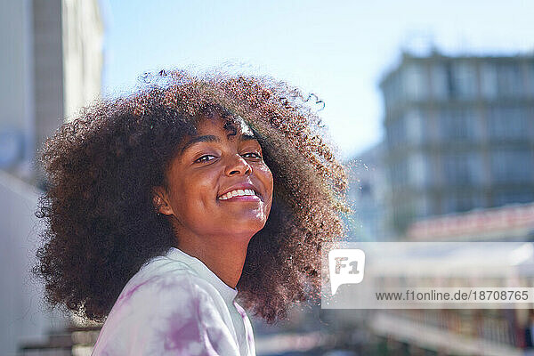Portrait happy  confident young woman in sunny city