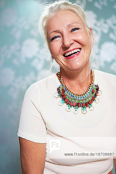 Portrait happy  beautiful senior woman wearing necklace