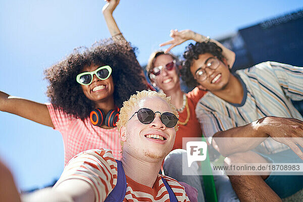 Selfie POV portrait happy young friends in sunny city