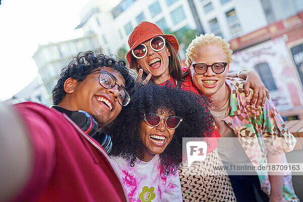 Selfie POV portrait happy young friends on urban balcony