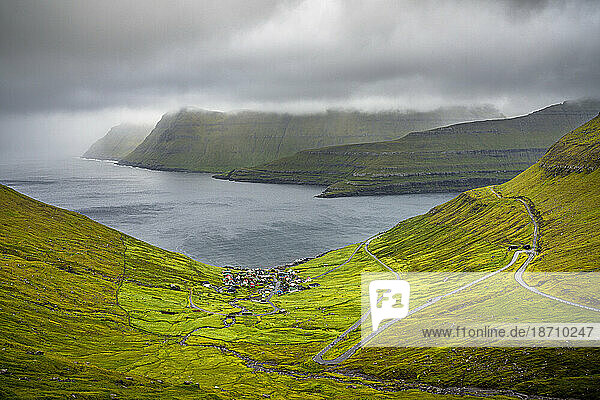 Storm clouds over the coastal village of Funningur along the fjord  Eysturoy Island  Faroe Islands  Denmark  Europe