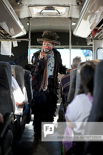 An evangelical Christian clown preaches the gospel on a bus during a performance outside of Oaxaca  Mexico.