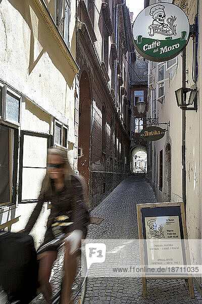 Female cyclist in the Alleyways of Ljubljana Old Town  Slovenia