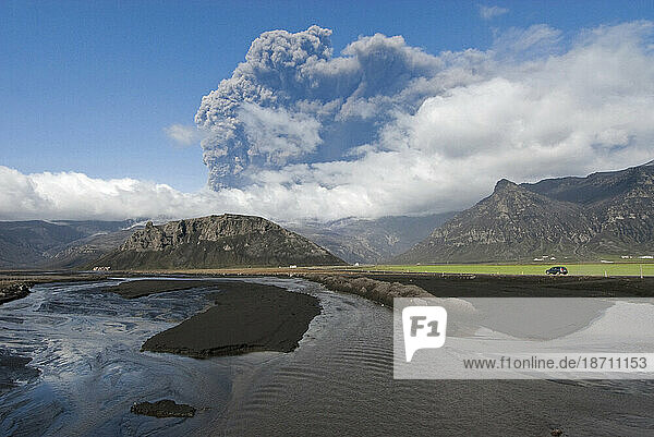 Viewed from the coastal highway  the ash plume continues to erupt from Eyjafjallajokull Volcano near Skogar  Iceland.