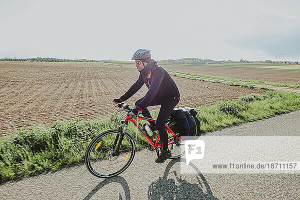 A cyclist riding bike in a rural place in Germany
