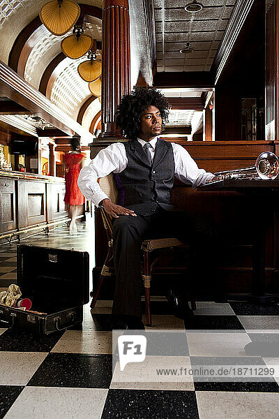 A man poses with a trumpet at a restaurant in Northeast Minneapolis  Minnesota.