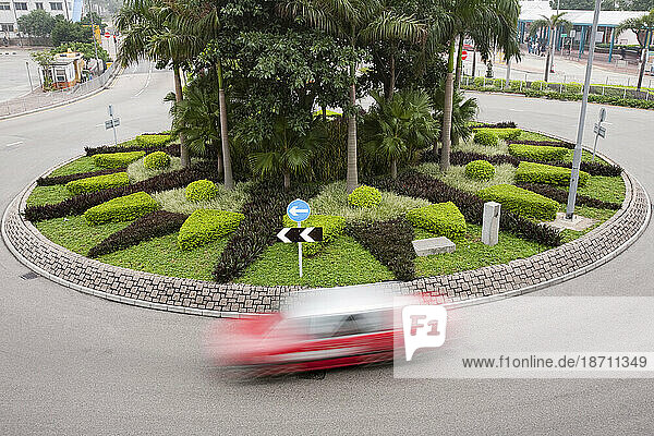 Taxi going round a roundabout in Hong Kong  China.