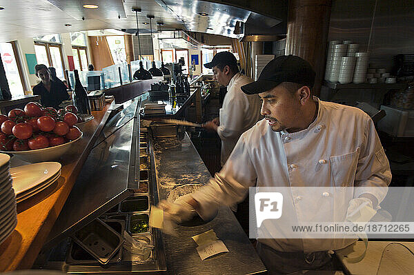 A hispanic worker works as a cook at an upscale Italian restaurant  Cucina Colore  in the Cherry Creek North area of Denver  Colorado