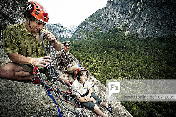 Two climbers and a young boy at the top of a climb in Yosemite  June 2010.