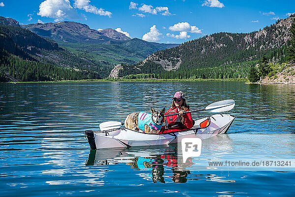 Woman and Husky Kayaking Lake San Cristobal in Colorado