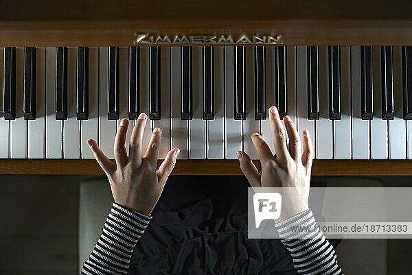 Close up of hands playing the piano and moving across the keyboard