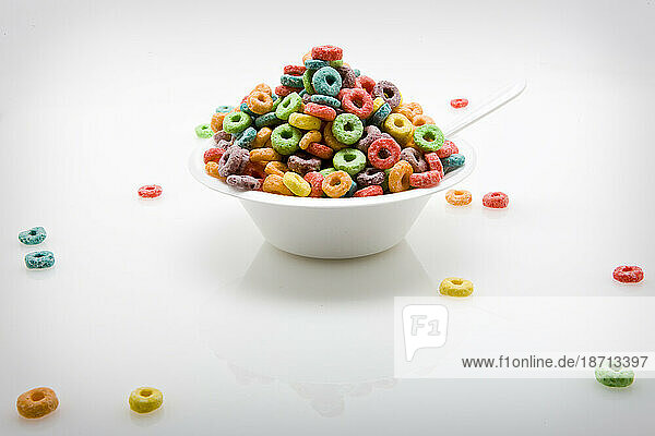 An overflowing bowl of sugar cereal (studio).