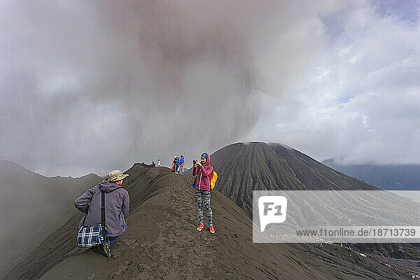 Hikers standing on top of the mountain and taking a pictures Java Indonesia.