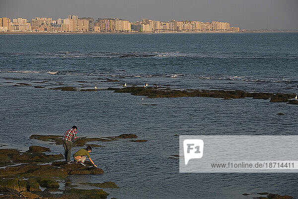 A couple looks at the Atlantic Ocean in Cadiz  Andalusia  Spain.