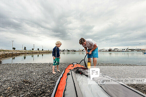 Father and son preparing a kayak