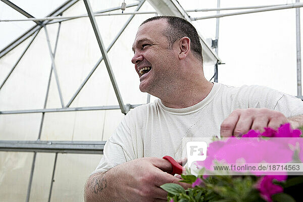 Inmate growing flowers for prison grounds.