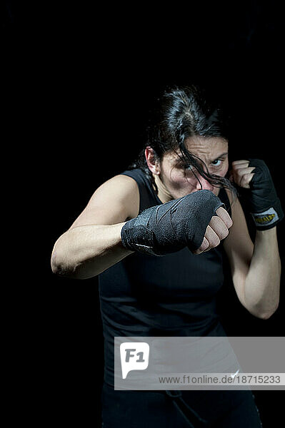 Portrait of female boxer throwing punch  Toronto  Ontario