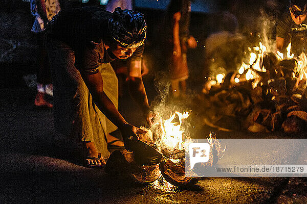 Person burning coconut husks at night  Tabanan  Bali  Indonesia
