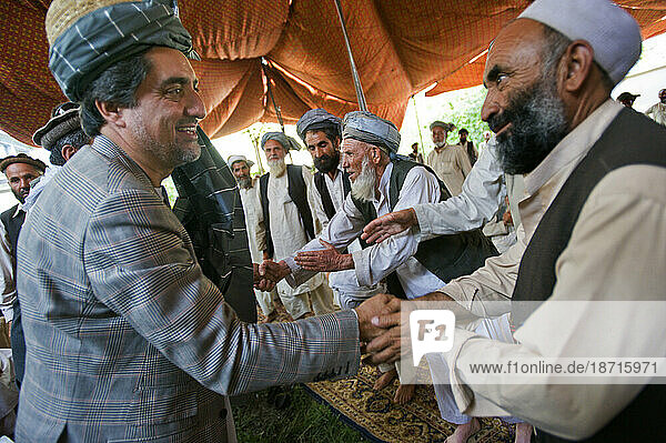 A presidential candidate of the Tajik tribe greets Pashtun leaders who have pledged their support for his candidacy  at a meeting in Kabul.