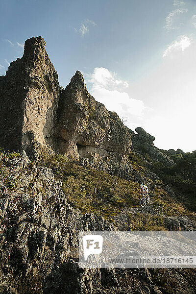 A girl rides her mountainbike climbing on a rocky place in Hidalgo  Mexico.