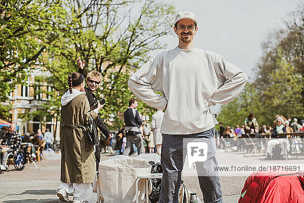 man stands happy and proud at second hand flee market in europe