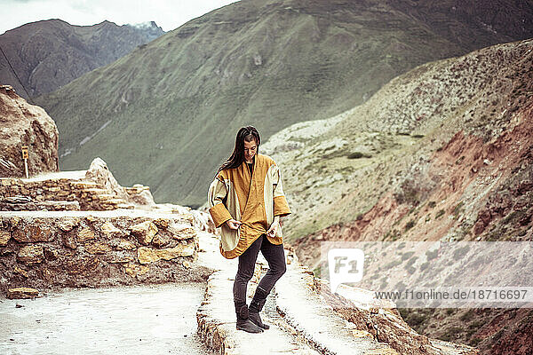 Androgynous mixed race dancer in salt farm on mountain side