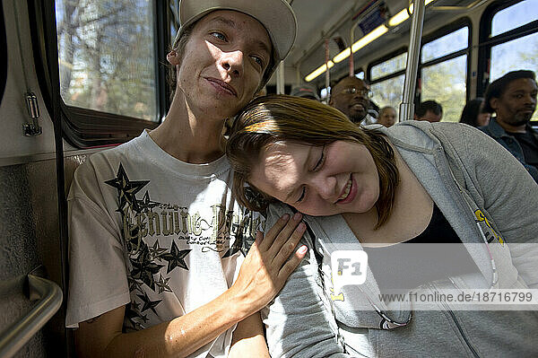A young man (20) who was a homeless teen meth addict  and his friend  also a recovering addict  share a moment on the bus enroute to mandatory urine tests and counciling session