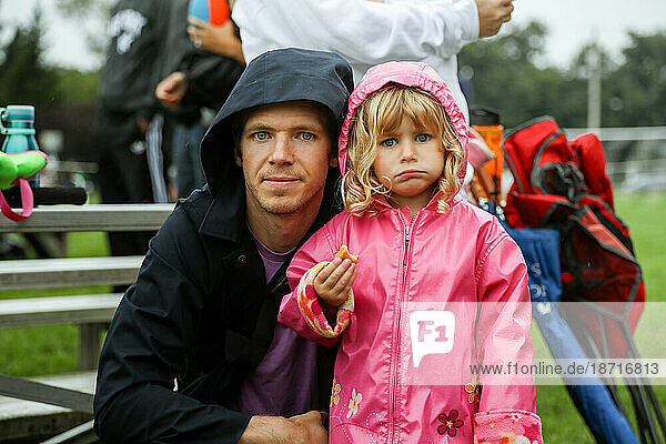 portrait of father and daughter outside at sports activity