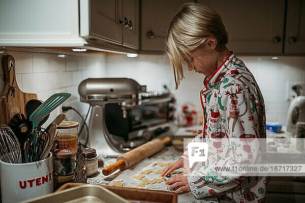 Girl making cookies in holiday pajamas