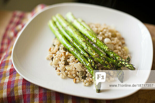 Homegrown organic asparagus sits atop a bed of Israeli couscous in a Seattle  Washington  home.