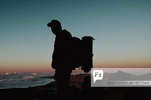 A hiker with backpack at sunset in the volcano Teide  Tenerife