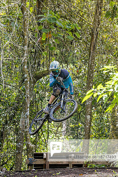 Mountain Biker Riding Through The Rainforest In Bali  Indonesia