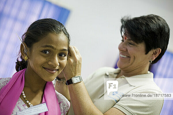A girl is fitted with hearing aids during a Starkey Hearing Foundation mission.