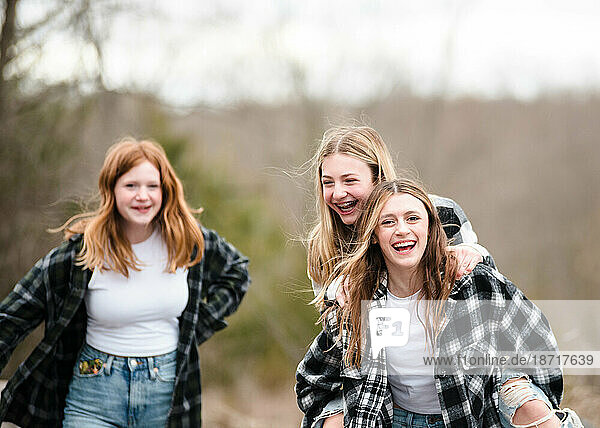Three beautiful teen girls having fun together outdoors.