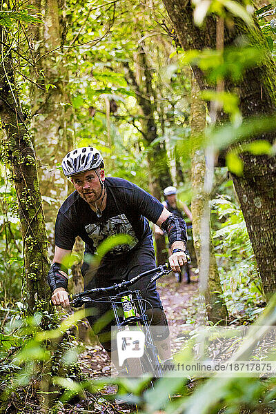 Mountain Biker Riding In Forest Trail Of Bali  Indonesia