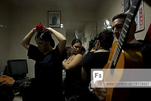Flamenco dancers  or bailaores  and singers  or cantaores  and a guitarrist get ready for a performance backstage in Cadiz  Andalusia  Spain.