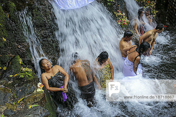 Balinese ceremony in waterfall Bali Indonesia.