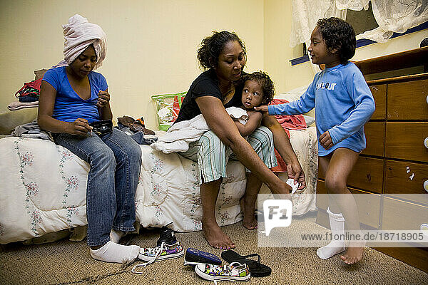 Selena Pina  a homeless mother of four  gets her children dressed for school at the Family Promises Center in Sacramento  CA.