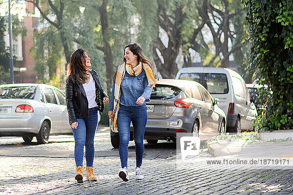 Women crossing road in city