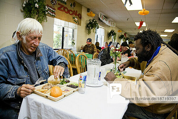 A man enjoys a free meal at Loaves and Fishes  a non-profit that helps homeless people in Sacramento  California.